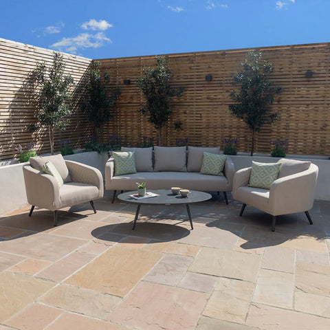 Outdoor sofa set with beige cushions and coffee table on stone patio