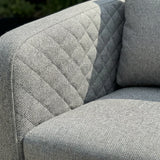 Grey fabric sofa with quilted backrest and textured seat cushion detail