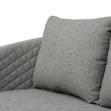 Grey fabric sofa with quilted arm detail and matching cushion close-up