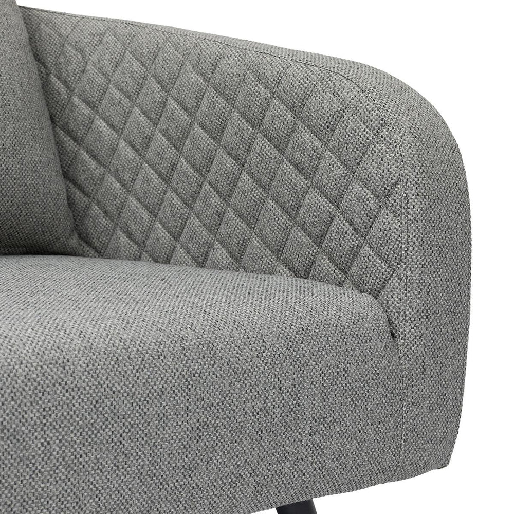 Grey fabric sofa with diamond quilted backrest and textured seat close-up