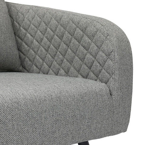 Grey fabric sofa with diamond quilted backrest and textured seat close-up