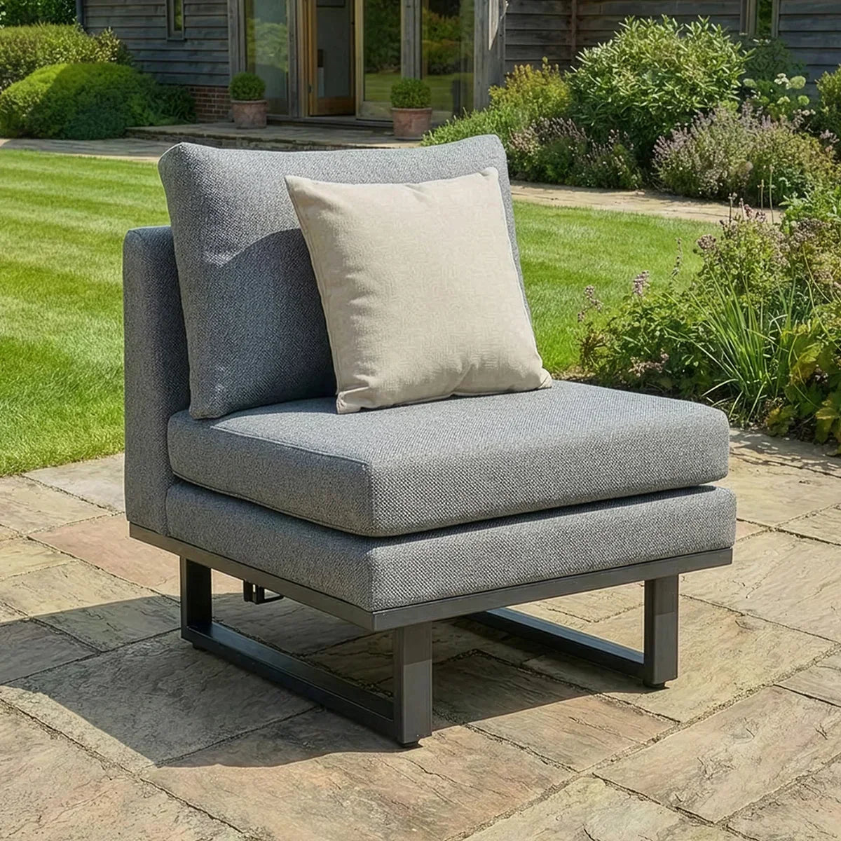 Grey garden chair with metal frame and beige cushion on patio