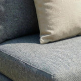 Grey fabric sofa seat with close view of beige cushion detail