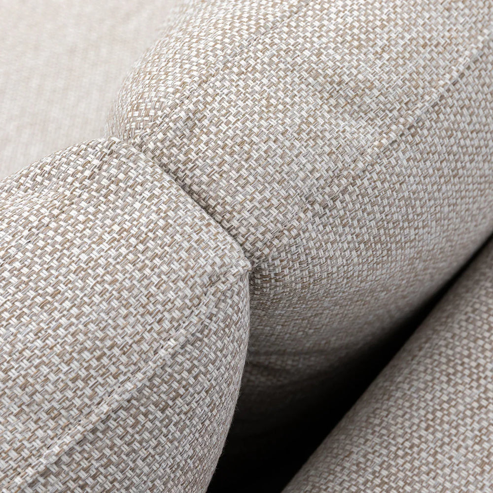 Closeup of beige fabric sofa armrest showing textured upholstery detail