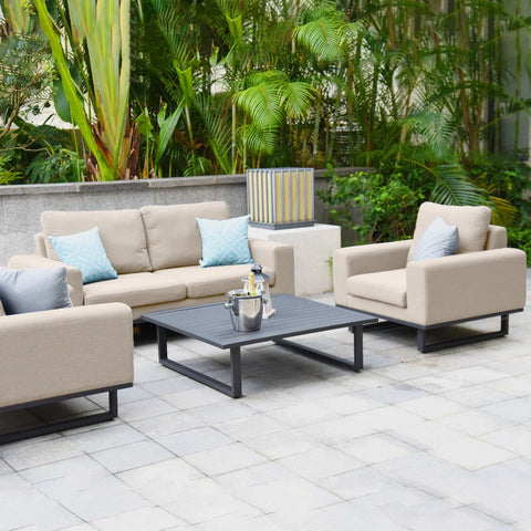 Beige outdoor garden sofa set with metal coffee table and cushions on a patio