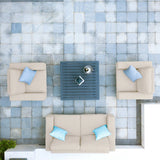 Outdoor patio furniture set with beige sofa, two armchairs and a grey coffee table, top view