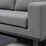 Close-up of grey fabric sofa armrest and cushion with black metal base