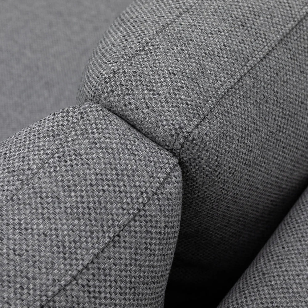 Close-up of grey fabric sofa armrest showing textured upholstery detail