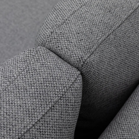Close-up of grey fabric sofa armrest showing textured upholstery detail