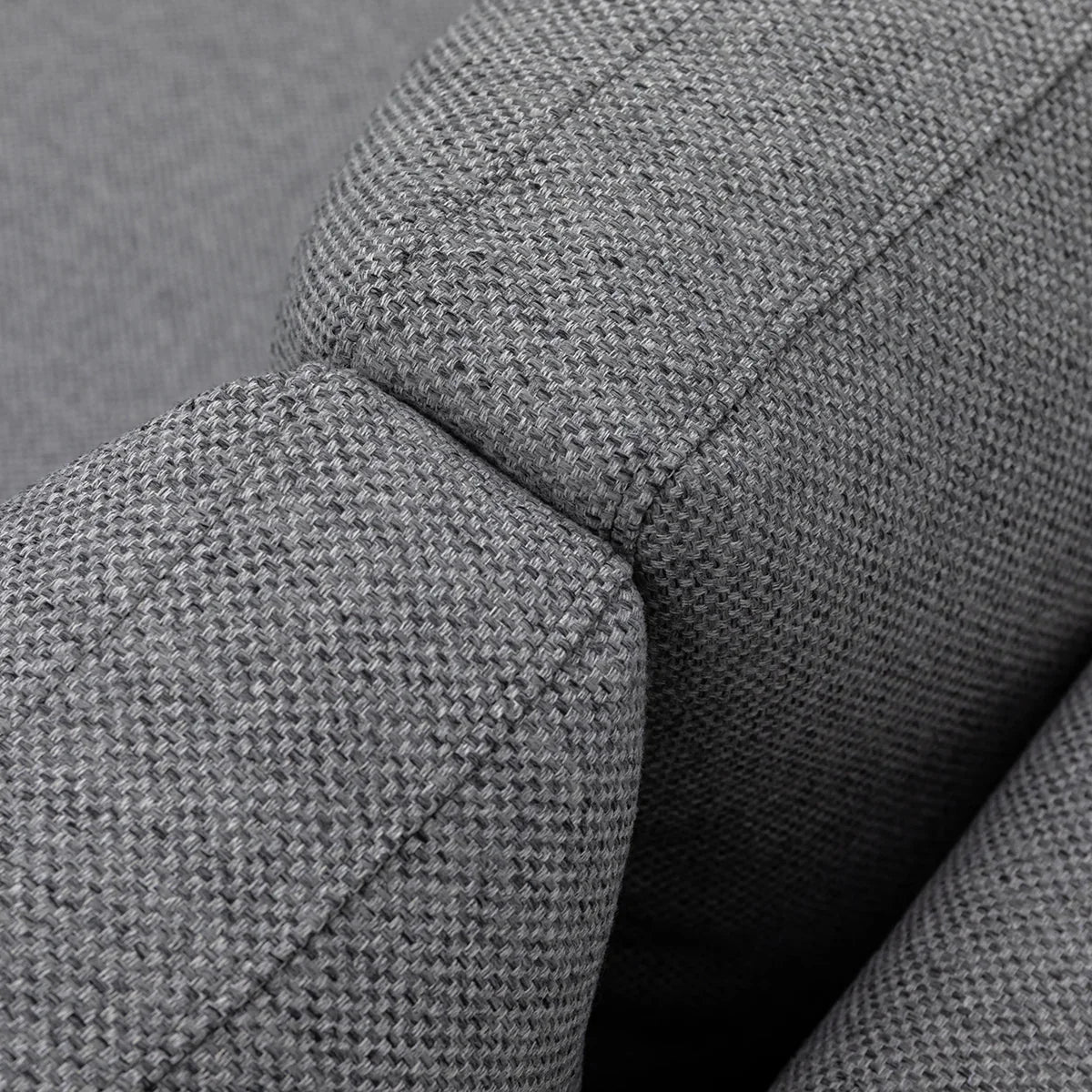 Close-up of grey fabric sofa armrest showing textured upholstery detail