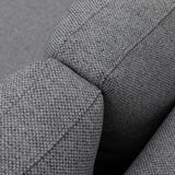 Close-up of grey fabric sofa armrest showing textured upholstery detail