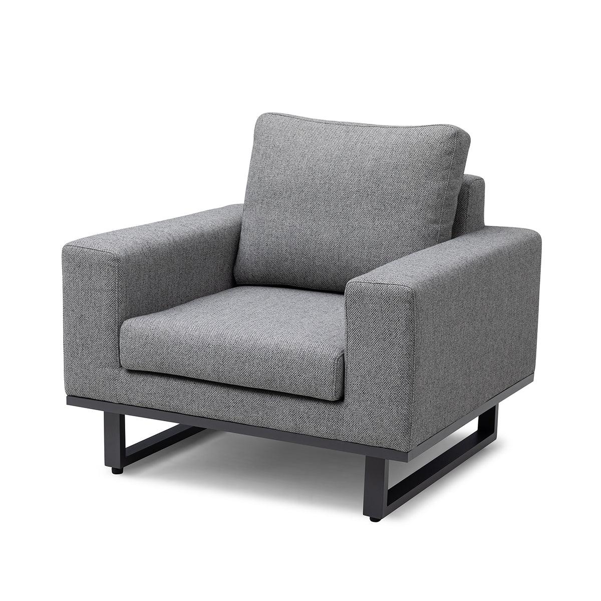 Grey fabric armchair with wide arms and black metal base, front angle view
