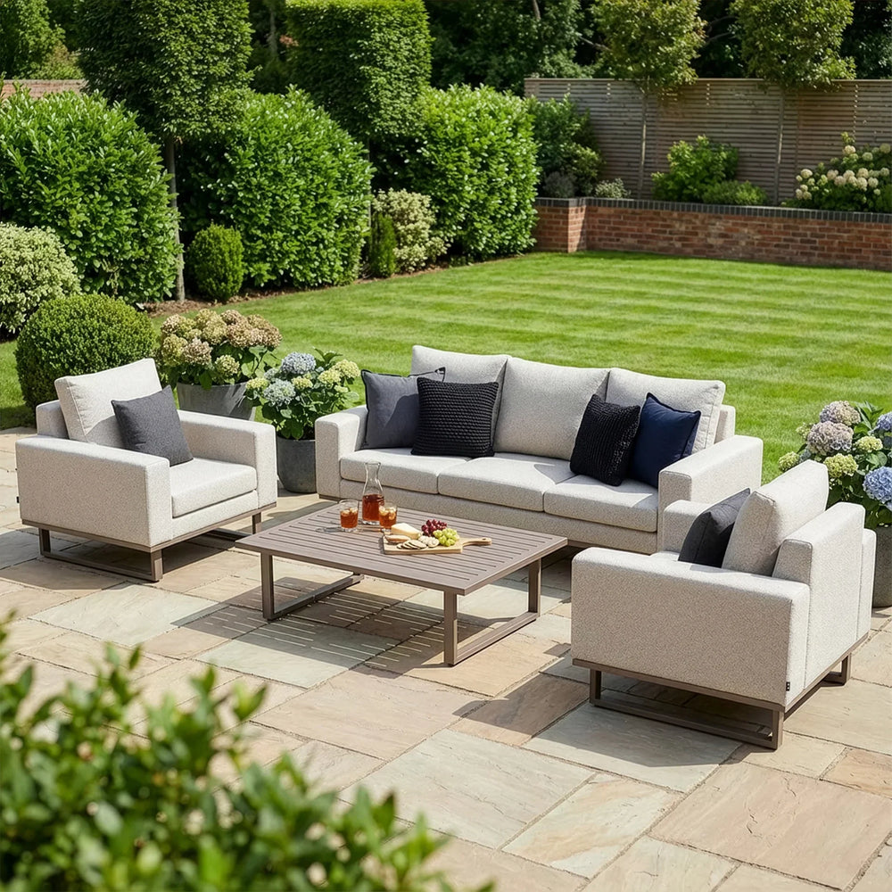 Beige garden sofa set with armchairs and grey cushions on patio, wooden coffee table in center