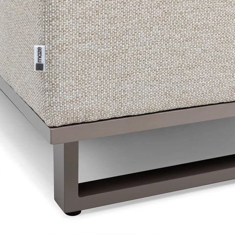 Detail of fabric sofa corner with beige textured upholstery and metal frame base