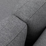 Close-up of grey fabric sofa armrest showing textured upholstery and stitching