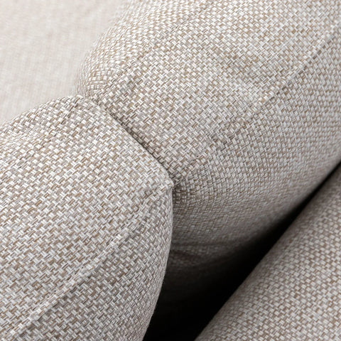 Close-up of beige fabric sofa arm and cushion texture