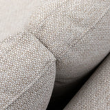 Close-up of beige fabric sofa arm and cushion texture