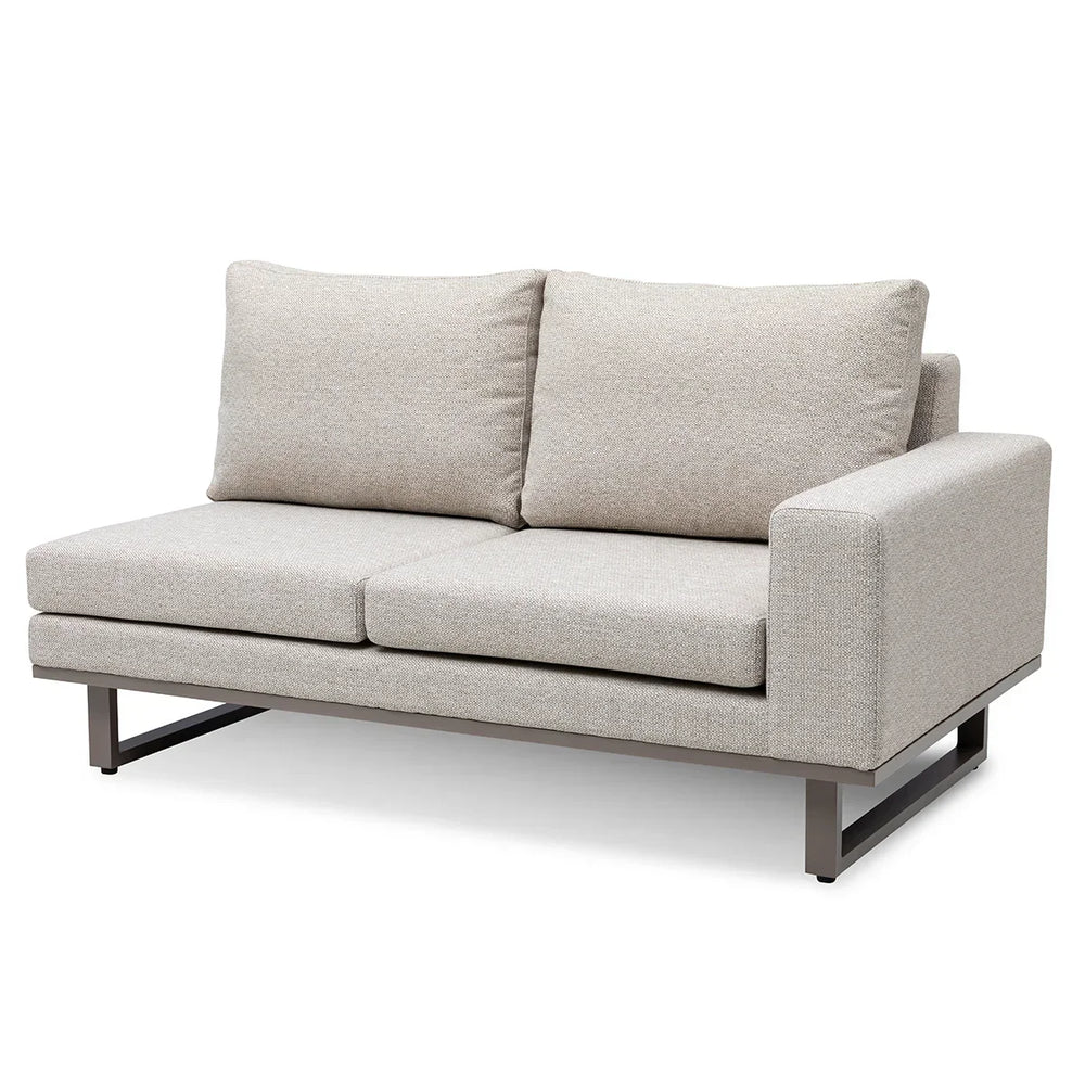 Beige two seater fabric sofa with right armrest and metal legs on white background