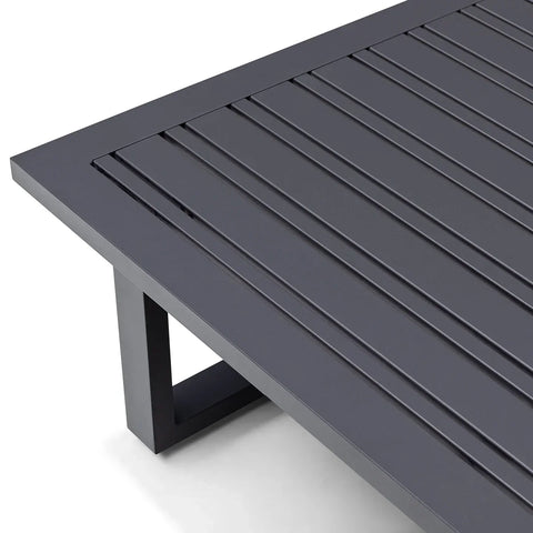 Close-up of dark grey slatted metal garden table with modern rectangular leg design