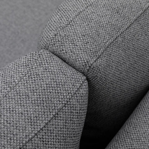 Closeup of grey fabric sofa arm with textured upholstery and stitching detail