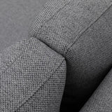 Closeup of grey fabric sofa arm with textured upholstery and stitching detail
