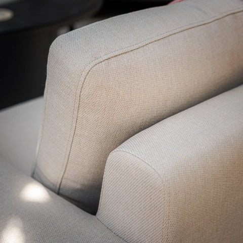 Close-up of beige fabric sofa cushions with textured upholstery