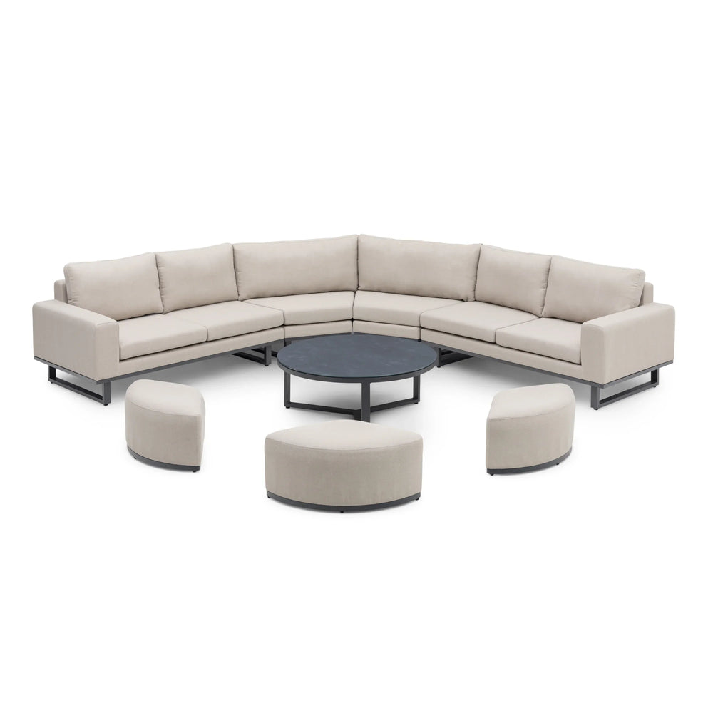 Outdoor corner sofa set with beige cushions, round coffee table and curved stools