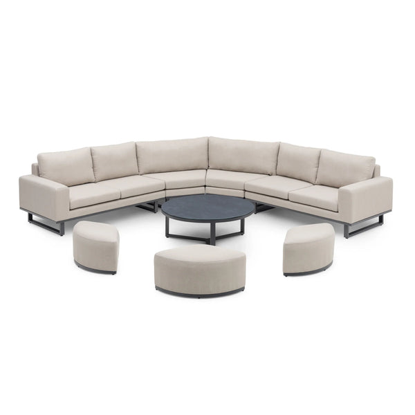 Outdoor corner sofa set with beige cushions, round coffee table and curved stools