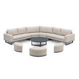 Outdoor corner sofa set with beige cushions, round coffee table and curved stools