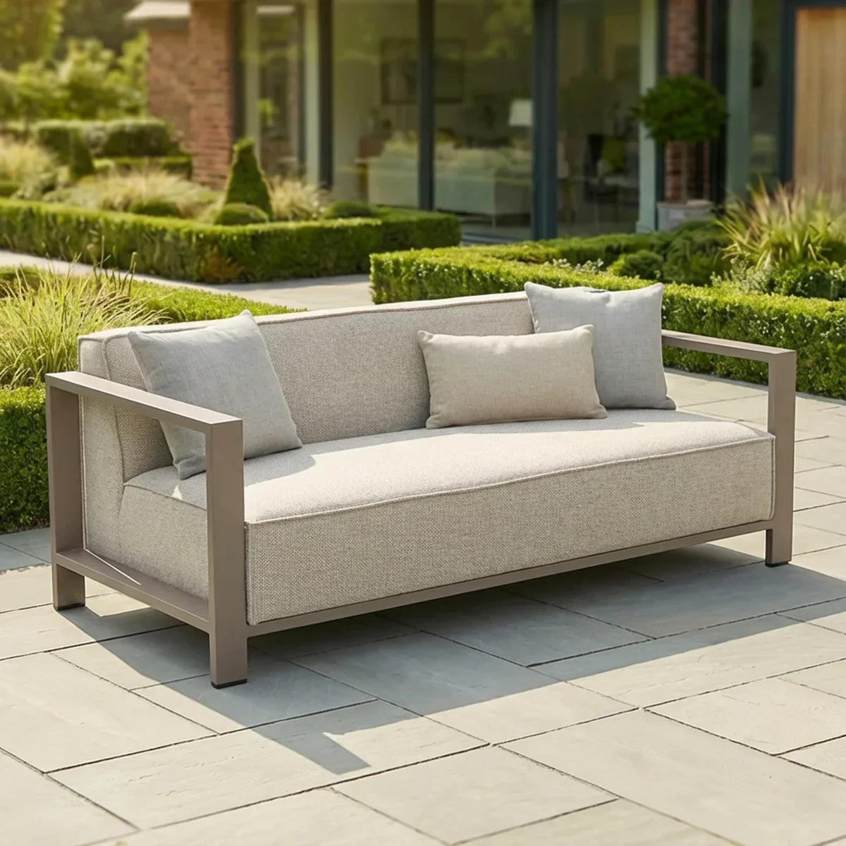 Outdoor two-seater garden sofa with light beige cushions on modern patio