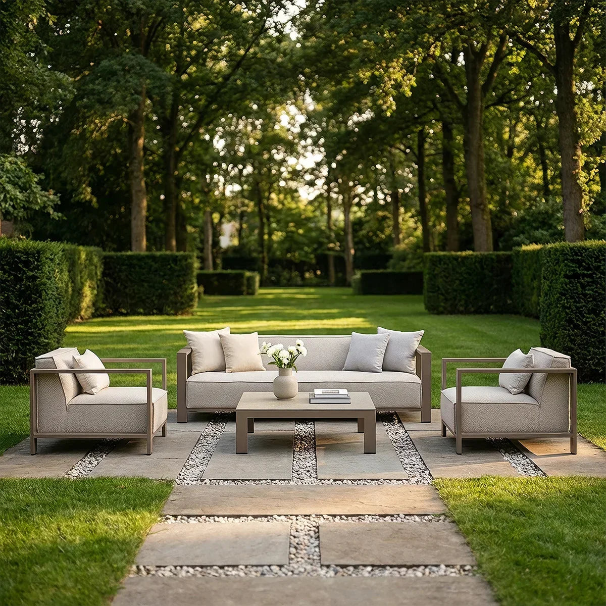 Modern outdoor sofa set with beige cushions and coffee table on a stone patio in garden