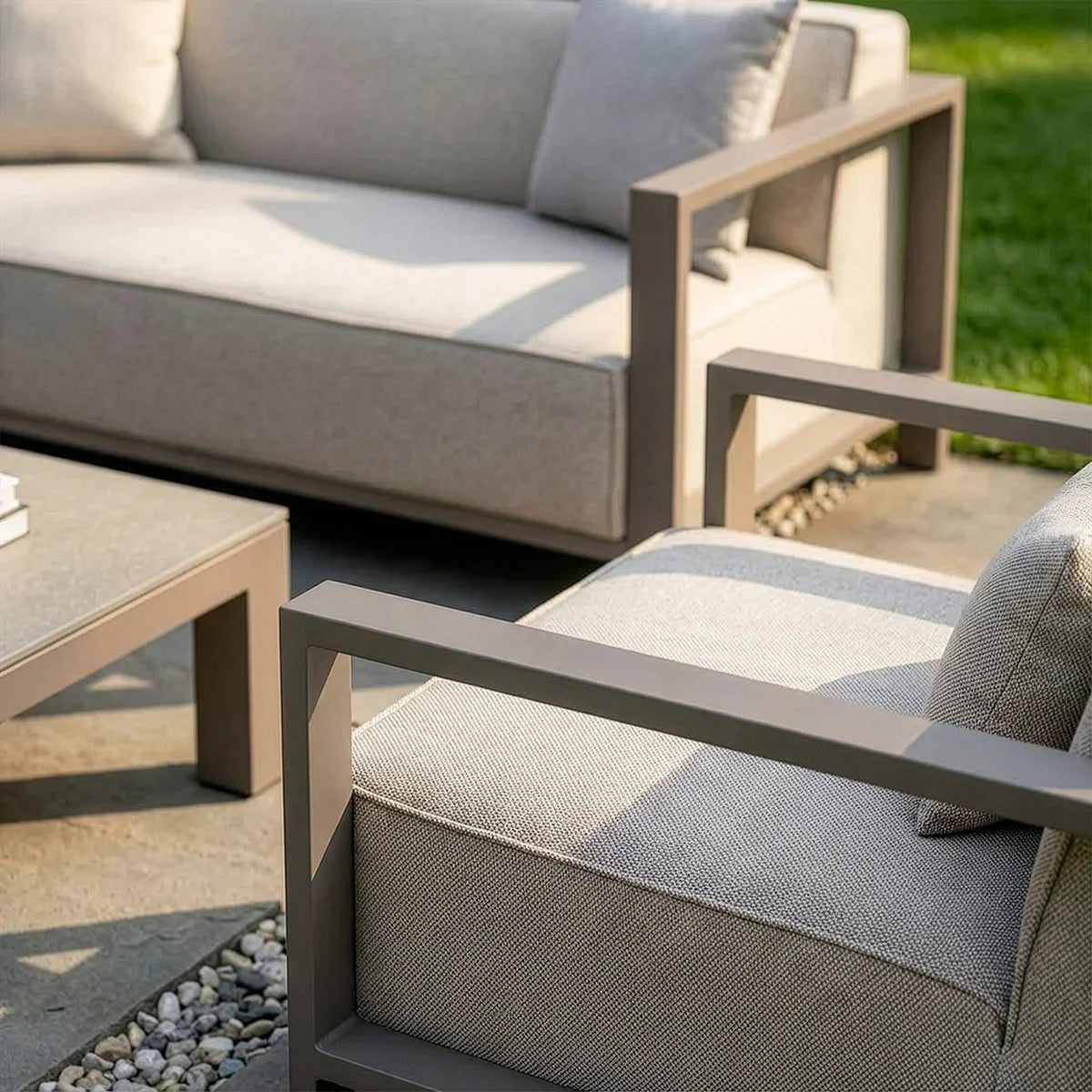 Outdoor lounge set with taupe metal frame and grey cushions on patio