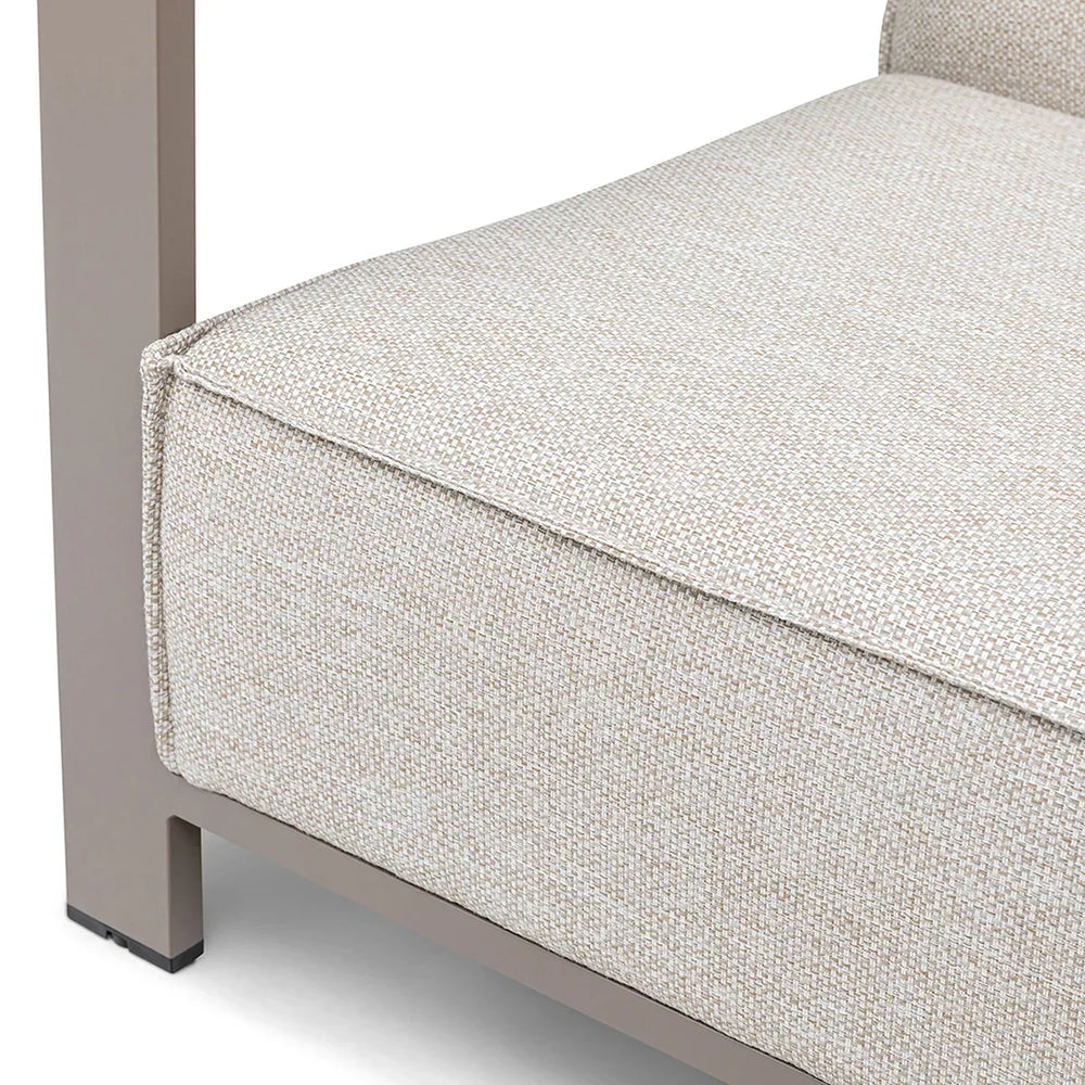 Closeup of beige fabric sofa seat cushion with modern metal frame corner