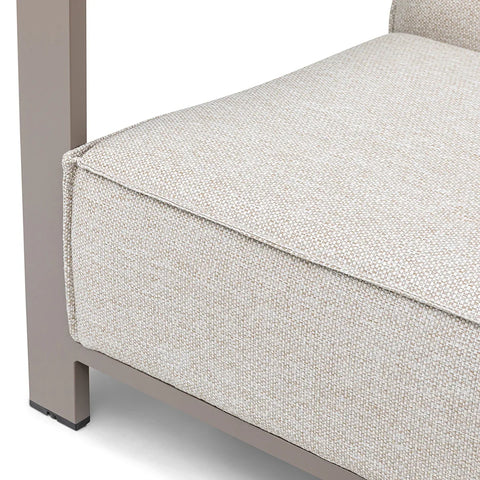 Closeup of beige fabric sofa seat cushion with modern metal frame corner