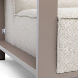 Closeup of beige sofa armrest with textured fabric cushion and taupe metal frame