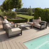 Modern outdoor garden sofa set with grey cushions by pool on patio