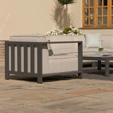 Grey aluminium outdoor corner sofa set with beige cushions and patterned throw pillows on patio
