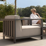 Outdoor aluminium armchair with beige cushions on patio seating area