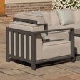 Modern outdoor armchair with grey aluminum frame and beige cushions on patio