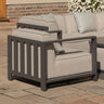 Modern outdoor armchair with grey aluminum frame and beige cushions on patio
