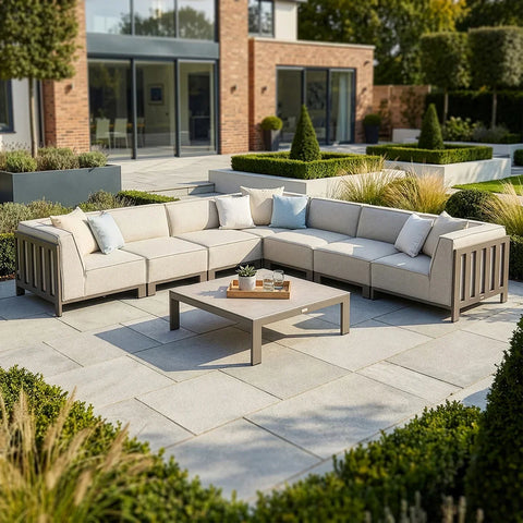 Beige outdoor corner sofa set with cushions and coffee table on modern patio