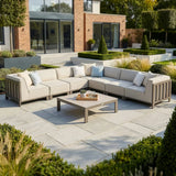 Beige outdoor corner sofa set with cushions and coffee table on modern patio