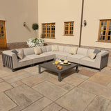 Grey outdoor corner sofa set with cushions and coffee table on patio