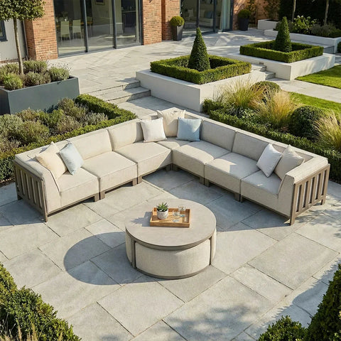 Beige outdoor corner sofa set with cushions and round coffee table on patio