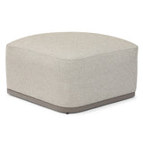 Beige textured ottoman with rounded square shape and low base, shown at slight angle