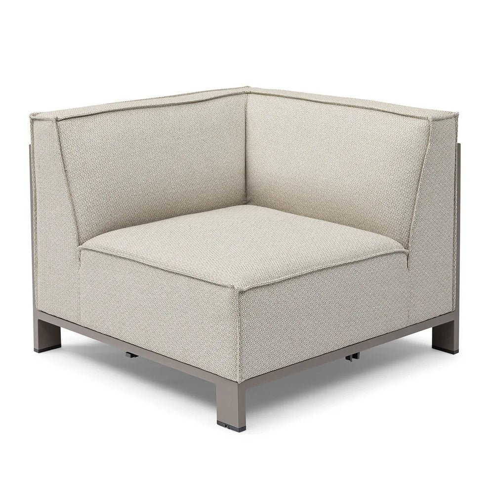 Modern corner sofa section with beige fabric upholstery and metal base, angled view