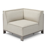 Modern corner sofa section with beige fabric upholstery and metal base, angled view