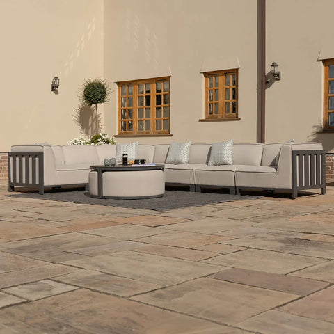 Beige outdoor corner sofa set with round coffee table on patio