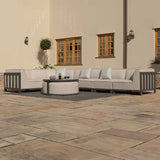 Beige outdoor corner sofa set with round coffee table on patio