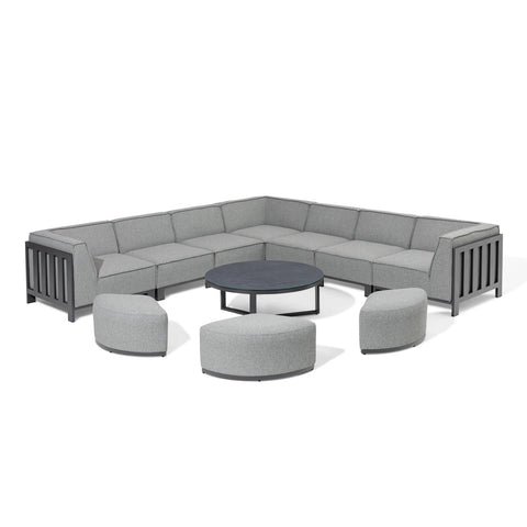 Grey corner outdoor sofa set with round coffee table and matching curved stools
